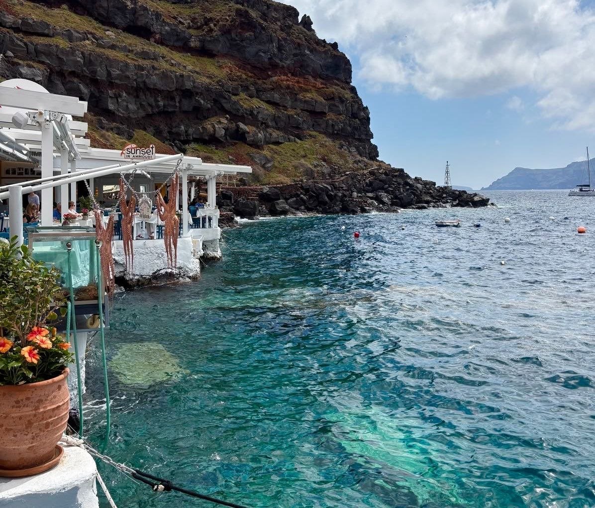 Traditional taverna at Ammoudi harbor Santorini with octopuses hanging to dry from the pergola